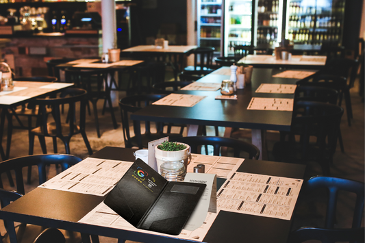 Open black NFC check presenter with a receipt on a restaurant dining table