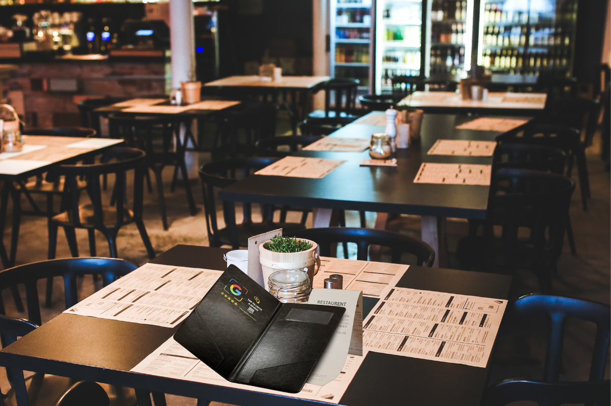 Open black NFC check presenter with a receipt on a restaurant dining table